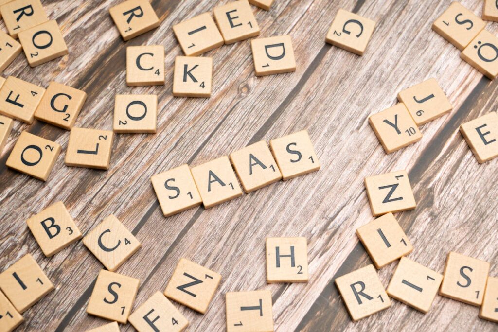 Wooden letter tiles spelling SaaS on rustic wood. Ideal for cloud computing and business concepts.